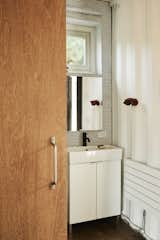 All the bathrooms, including the downstairs powder room, feature white penny tiling.