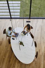 Slim pendants from Vibia hang above a Saarinen dining table from Knoll and Cherner chairs.