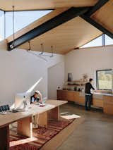 Custom pendants by GRT hang from above in the open kitchen and work area.