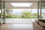 Upon entering the home, the eye is immediately drawn to the full panel of windows and the views beyond.