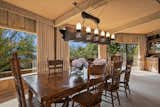 Expansive windows wrap around the open dining area, also located on the home’s main level.