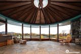 The home's centerpiece is a circular living area topped by a radial-beamed ceiling. A zigzagged wall of windows overlooks the lakefront location in College Village, about four miles southeast of downtown.