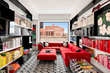 An adjacent library features brightly colored furniture and books that contrast with the black shelving and carpet. The Perrys completely renovated the apartment, which was also once home to the&nbsp;fashion icon C. Z. Guest.
