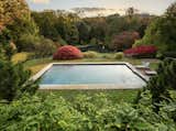 Lush landscaping surrounds a pool adjacent to the house.  Photo 8 of 11 in Paul Simon’s Grand Connecticut Estate Returns to the Market—This Time Asking $11.9M