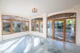 An airy sun room offers warm, natural light, and views of the garden.  Photo 7 of 11 in Paul Simon’s Grand Connecticut Estate Returns to the Market—This Time Asking $11.9M