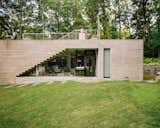“The idea was to create this total openness and informality and almost undomesticated domestic space,” says Leven. The concrete is textured by its forms on the outside but smooth where it cuts into the building—“almost as though you sliced into it with a knife,” adds the designer.
