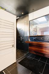 Whereas most vanities have a mirror above the sink, the Foust Residence bathroom has a window that looks into the trophy room.