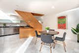 Inside, a central plywood staircase connects each of the four levels, including a finished basement. The ground floor, shown here, contains the kitchen and dining area.  Photo 3 of 13 in In Cambridge, a Plywood-Clad Home With a Twist Asks $850K