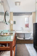 The en suite bathroom features a large vanity and soaking tub.