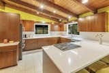 In the kitchen, updated cabinetry and an open-concept layout create a modern feel, which is enhanced by quartz countertops and all-new, stainless-steel appliances.  Photo 7 of 11 in A Michigan Midcentury With Colorful ’60s Flair Lists for $319K