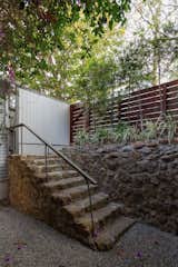 The sunken courtyard in front of the home is accessible via a gate from the street.
