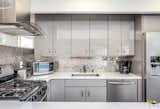 The kitchen echoed the front facade with a metallic backsplash and glossy cabinetry.