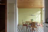 In the dining area located off the kitchen, a calming shade of green complements the timber-clad ceiling and exposed-brick walls. Black-and-white tiles line the floor.  Photo 6 of 12 in A British Architect’s Picturesque Prefab Seeks £1.2M