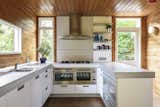 The kitchen was recently updated with custom cabinetry and open shelving. New stainless-steel appliances were also integrated as part of the renovation.   Photo 5 of 12 in A British Architect’s Picturesque Prefab Seeks £1.2M