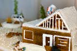 Microplaned gingerbread and caramelized isomalt comprise the L-shaped, gable-roofed home. 
