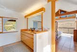 A connected bathroom is located behind the bedroom.  Photo 13 of 16 in Japanese Influences Grace This Bay Area Home Offered at $1.6M