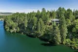 An aerial shot of the property shows the residence’s perch on a hilltop above the water.  Photo 15 of 15 in Moritz Kundig’s Historic Wallmark House Offers Lakefront Living for $1.1M