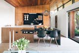 In the kitchen, Eames chairs flank a custom dining table, and the pendant is by Wever &amp; Ducré.