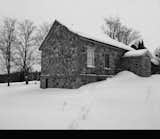 Exterior, Metal Roof Material, House Building Type, Gable RoofLine, and Stone Siding Material A look at the building exterior before the renovation.  Photos from A Toronto Couple Turn an Abandoned Schoolhouse Into an Elegant Country Getaway