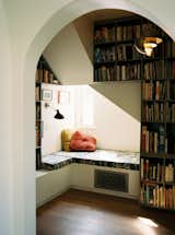 In the library, tucked beneath the renovated staircase, is a reading nook featuring cushion fabric by Sarah Morris for Maharam. The pendant is by Louis Weisdorf for Gubi, and the sconce is by Bernard Schottlander for DCW éditions.