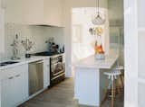 A closer look at the kitchen, which is painted in a crisp white shade by Farrow &amp; Ball.