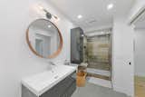 An oversized vanity in one of the bathrooms complements the large glass and stone shower.  Photo 8 of 13 in A Spruced-Up Sarasota Modern Seeks $800K in Fort Myers, Florida