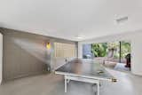 Sliding glass doors in the gaming area sited near the main entry offers direct outdoor access.  Photo 10 of 13 in A Spruced-Up Sarasota Modern Seeks $800K in Fort Myers, Florida
