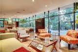 A large living area sits behind the expansive glass facade, which allows views of the front patio and lush garden.  Photo 2 of 14 in Case Study Architect Whitney R. Smith’s SoCal Residence Lists for $2.35M