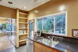 The dining area leads into a galley-style kitchen at the rear of the home.  Photo 5 of 14 in Case Study Architect Whitney R. Smith’s SoCal Residence Lists for $2.35M