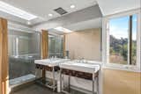 One of the home’s three full bathrooms features double vanities and a skylit shower.