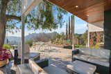 Around the corner, a partially shaded patio provides far-reaching views of the surrounding neighborhoods and canyons.