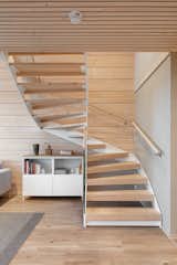 The stairs are comprised of a twisting metal frame and wooden steps.