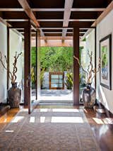 A floor-to-ceiling, mahogany-framed door offers a grand welcoming inside the seven-bedroom residence. Originally built in 2004 by Grant Kirkpatrick of KAA Design, the property is currently owned by American actor and producer Matt Damon and sited on a verdant .68-acre lot.
