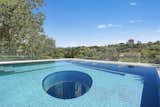 The wet-edge swimming pool features an oculus that looks down into the home office below, and inversely provides a view skyward when inside the office.&nbsp;