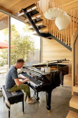 The staircase creates the perfect place for a concert grand piano that Anton Watts inherited from his father.