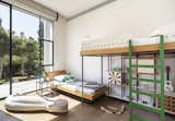 In Herzliya, a suburb of Tel Aviv, designer Sarit Shani Hay created a bedroom for two boys aged three and six. The two beds, arranged at staggered heights, provide the benefits of a bunk bed while allowing storage space.