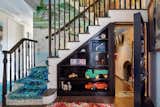 A bright playroom, complete with monkey bars and a chalkboard, can be accessed via a hidden door below the staircase that connects the home’s three levels.