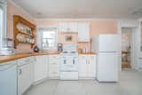 Notable features in the kitchen include heated floors, new appliances, and custom countertops.