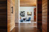 Wood-clad walls with tongue-and-groove detailing continue throughout the living spaces.