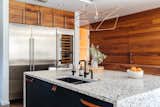 "We updated the dark ebony cabinets with walnut to match the floors," explains the current owners. "We also removed the pullout pantry doors to make room for a wall of sub-zero refrigeration, including wine storage and beverage drawers."