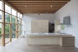 An exposed wooden frame and corrugated metal exterior give way to bright, white interiors. The plywood kitchen echoes the timber framing.  Photo 6 of 6 in Here’s What We Can Learn From Japanese Prefab Homes