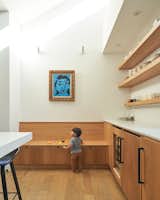 Mateo plays on a built-in bench along one wall in the kitchen.