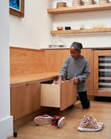 The bench doubles as storage with built-in drawers underneath.