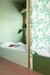 Nine-year-old Herborg’s ensuite bathroom (previously pictured) matches her bedroom, which is painted almost entirely in Cooking Apple Green by Farrow &amp; Ball. The color was selected by Thurmann-Moe to complement the floral wallpaper—Secret Garden by Cole &amp; Son—which was chosen by Herborg herself. “She is so at one with her room, and it’s so obvious that she is in her own space,” says Thurmann-Moe.