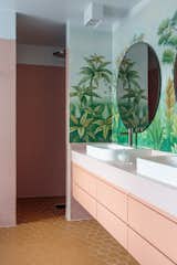 This family home near the town of Kongsberg, Norway, is built inside an enormous greenhouse. One of the bathrooms features jungle-inspired wallpaper from Etsy retailer AwallonDesign.