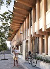 Residents Jorge Browne with his daughter in the communal courtyard that runs along the front of the structure.