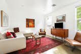 In the modern two-bedroom unit, the living area features a vibrant rug that pops against the warm-toned furniture.