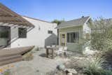 Native landscaping in the backyard sets the scene to enjoy al fresco dining.