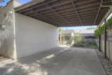 On the side of the home is a covered carport, which is accessed via an electric driveway gate.