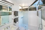 Clerestory windows invite light into the bathroom while also ensuring privacy.